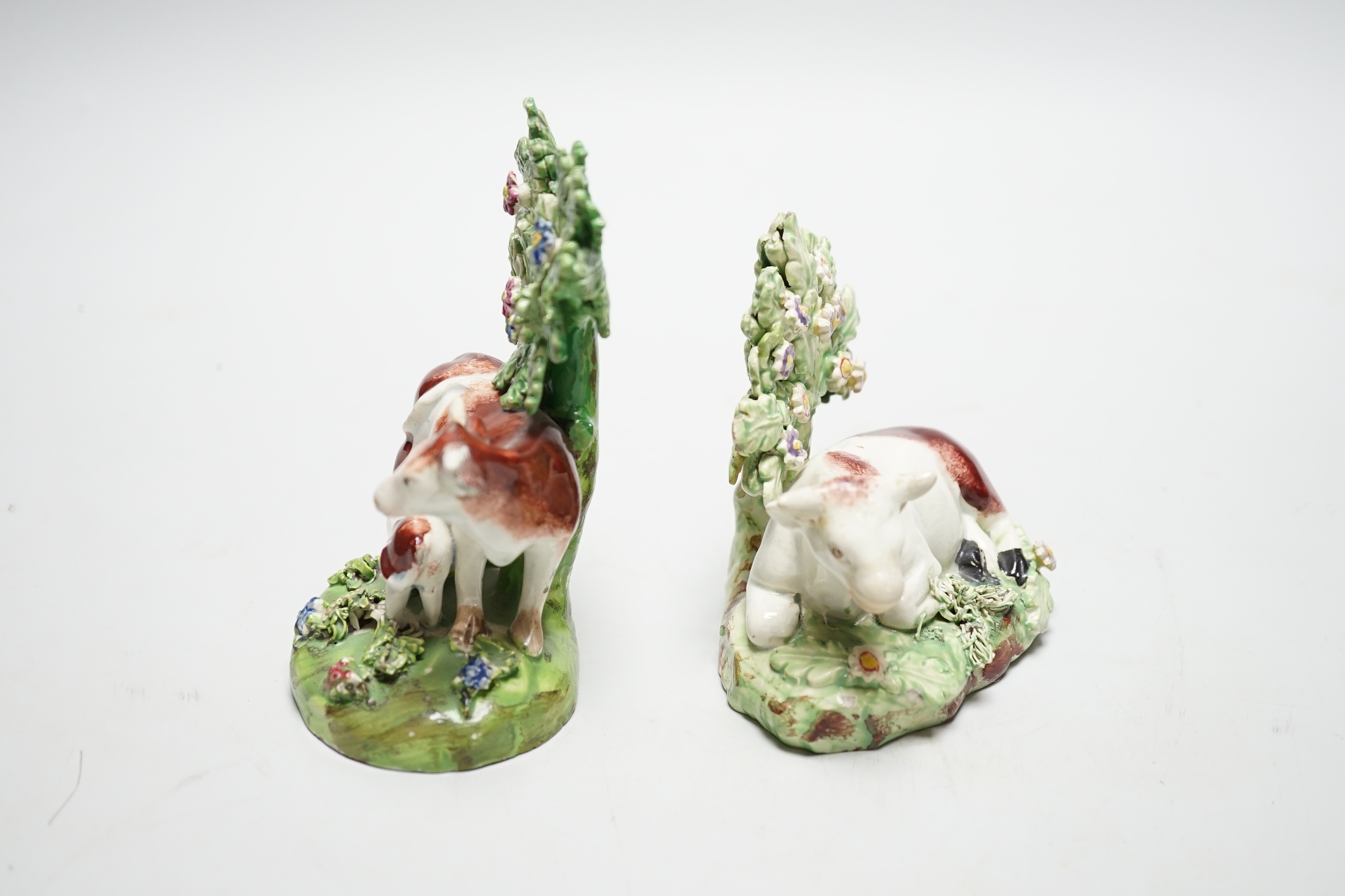 Two Staffordshire pearlware cow groups, c.1820-30, tallest 12cm